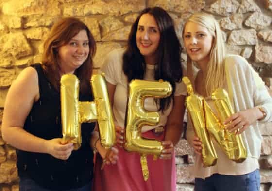 bride and bridesmaids hold gold hen party balloons