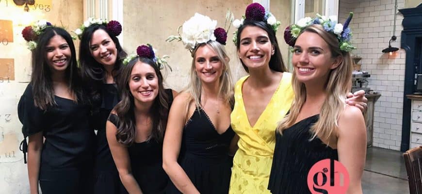 Group of women wearing flower crowns at hen party event in London.